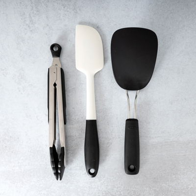 GOOD GRIPS<sup>&reg;</sup> Cookware Set - Set includes 9'' Locking Tongs with Nylon Heads. Nylon Flexible Turner and Spatula. All are heat resistant, won't discolor and are dishwasher safe.
